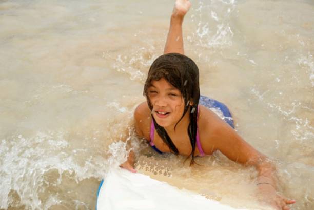 istock Summer Dream Vacation in Hawaii - A glrl enjoying a surfboard - beautiful beach fun water wave 1135794606