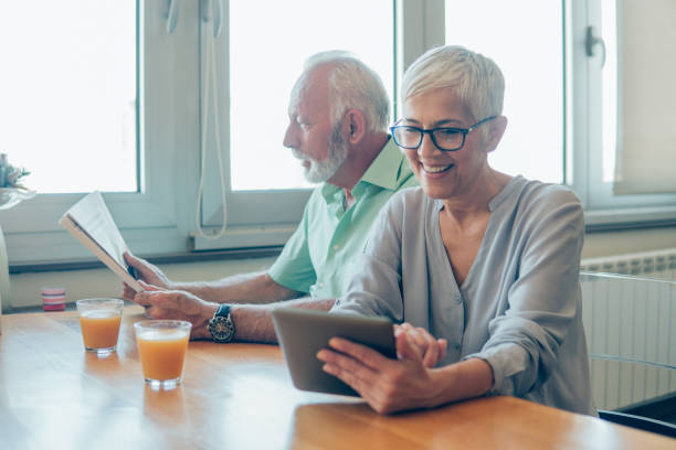 istock Couple reading newspapers and using digital tablet 1135796886