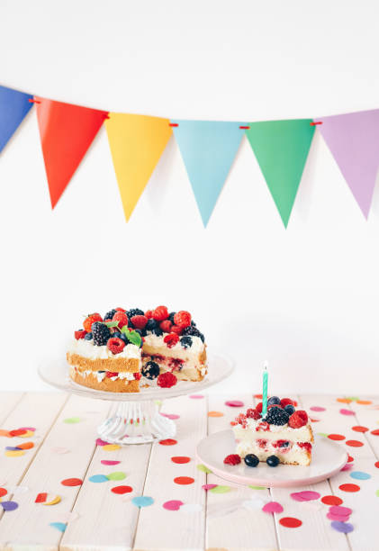 istock Berry birthday cake with colourful confetti and bunting 1135797109