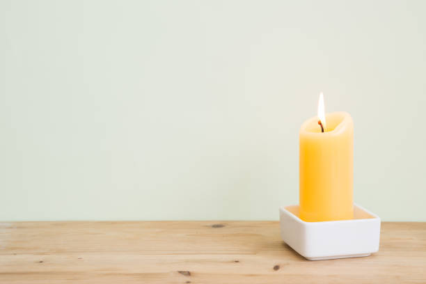 Natural home decor burning candle on wooden table