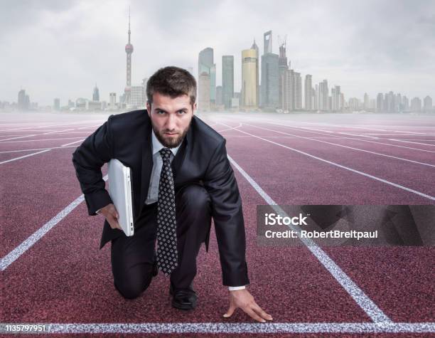 Attractive Business Man With A Note Book Under His Arm On A Race Track Stock Photo - Download Image Now