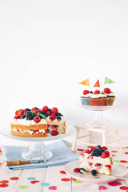 istock Berry cake and chocolate cupcakes with colourful confetti 1135798005