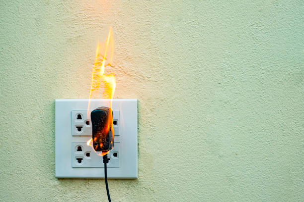 istock On fire electric wire plug Receptacle wall partition,Electric short circuit failure resulting in electricity wire burnt 1135799260