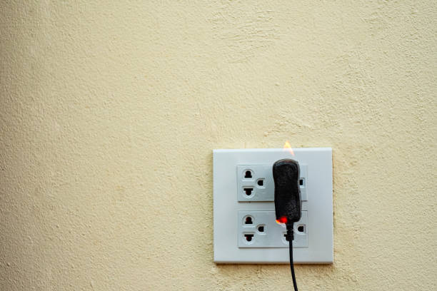 istock On fire electric wire plug Receptacle wall partition,Electric short circuit failure resulting in electricity wire burnt 1135799266