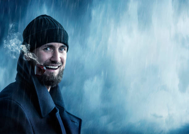 istock Attractive man smoking a pipe in the rain 1135799270