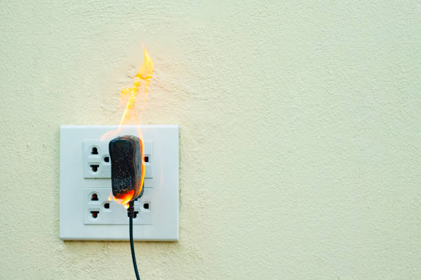 istock On fire electric wire plug Receptacle wall partition,Electric short circuit failure resulting in electricity wire burnt 1135799277