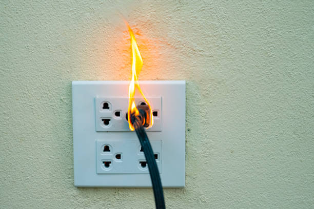 istock On fire electric wire plug Receptacle wall partition,Electric short circuit failure resulting in electricity wire burnt 1135799279