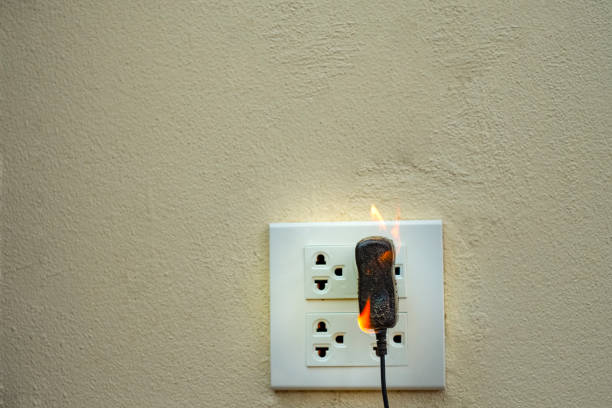 istock On fire electric wire plug Receptacle wall partition,Electric short circuit failure resulting in electricity wire burnt 1135799282