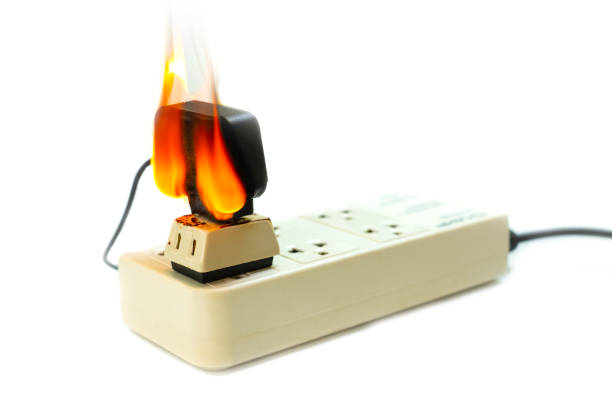 istock On fire electric wire plug Receptacle and adapter on white background, Electric short circuit failure resulting in electricity wire burnt 1135799290