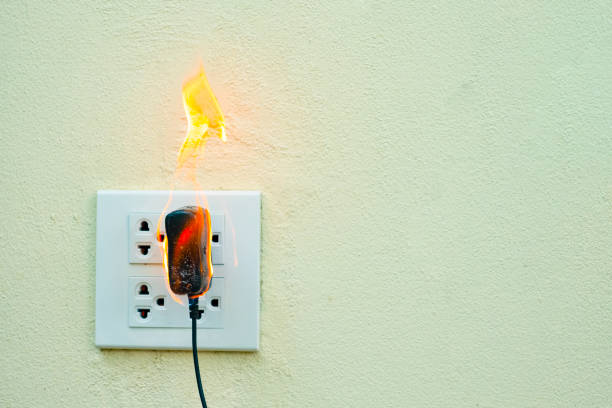 istock On fire electric wire plug Receptacle wall partition,Electric short circuit failure resulting in electricity wire burnt 1135799312
