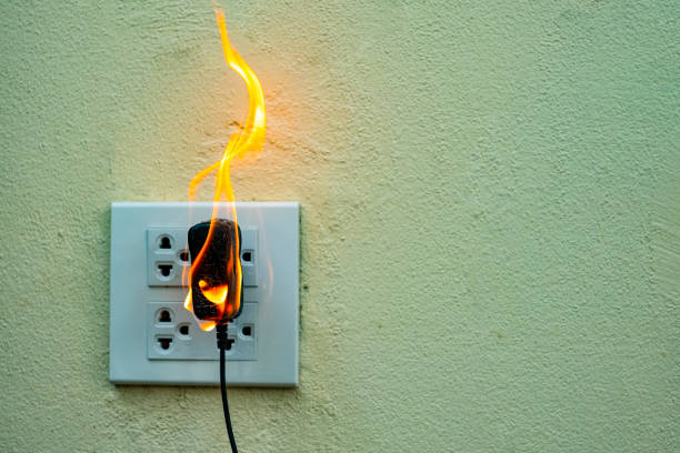 istock On fire electric wire plug Receptacle wall partition,Electric short circuit failure resulting in electricity wire burnt 1135799314