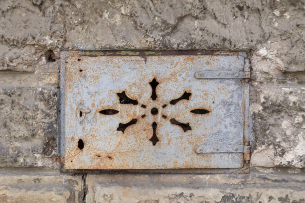 istock Old metal plate on stone wall 1135799532