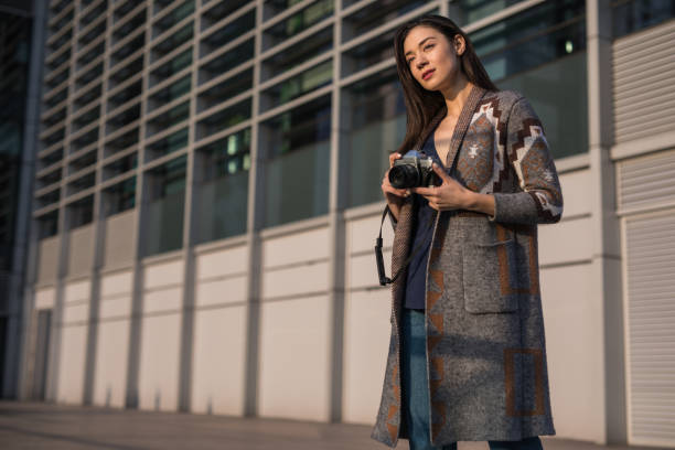 istock Pretty woman with digital camera 1135800587