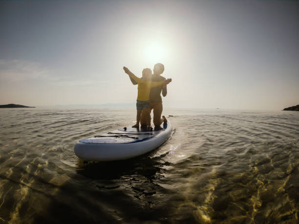 istock Mother and son having fun with paddle board 1135800674