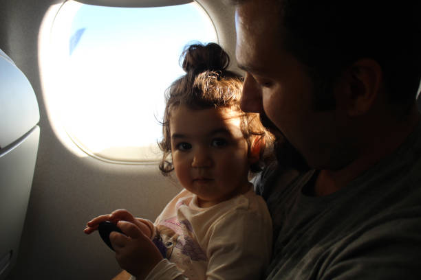 istock baby and father in airplane 1135800679