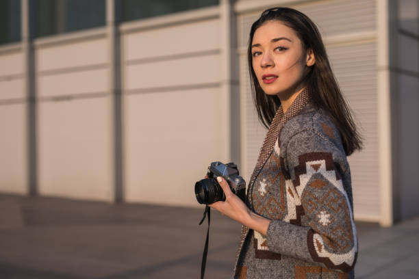 istock Charming girl with photo camera 1135800735