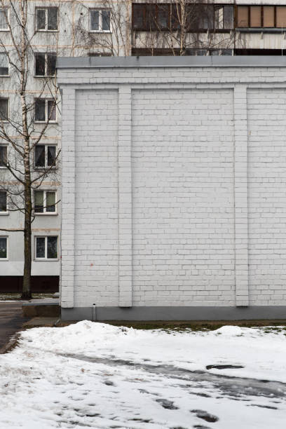 Blank ad space on a white brick wall of a building in the street outside - Whiteboard-like frame for information - plain wall
