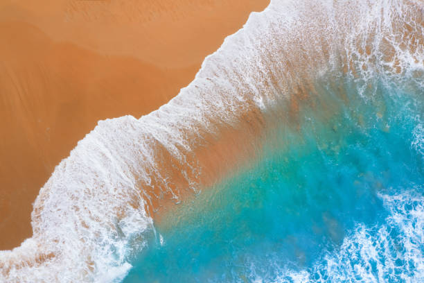waves and sand with ocean stock photo