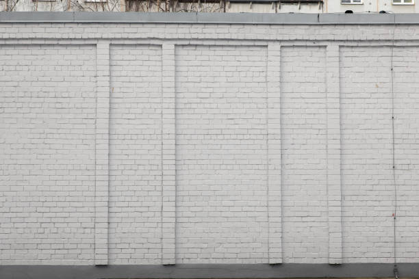 istock Blank ad space on a white brick wall in the street outside 1135801554