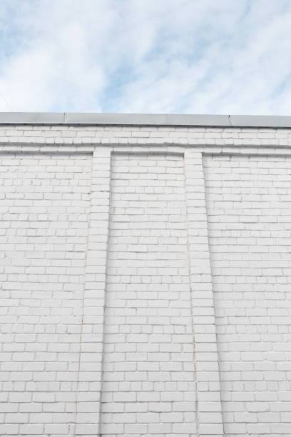 istock Blank ad space on a white brick wall in the street outside 1135802151