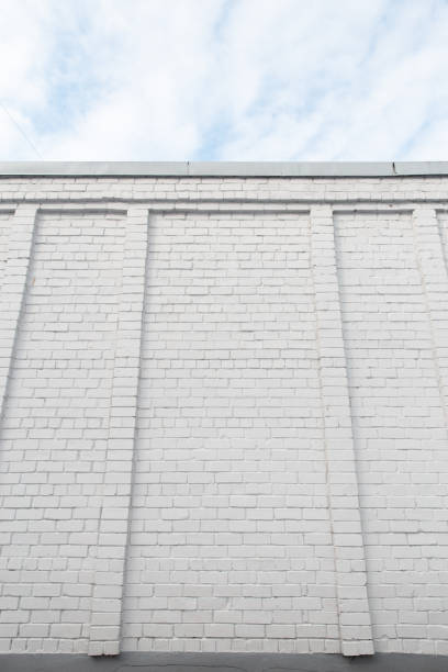 istock Blank ad space on a white brick wall in the street outside 1135802189