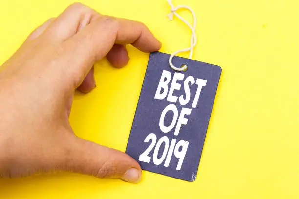 Photo of closeup hand holding tag with best of 2019