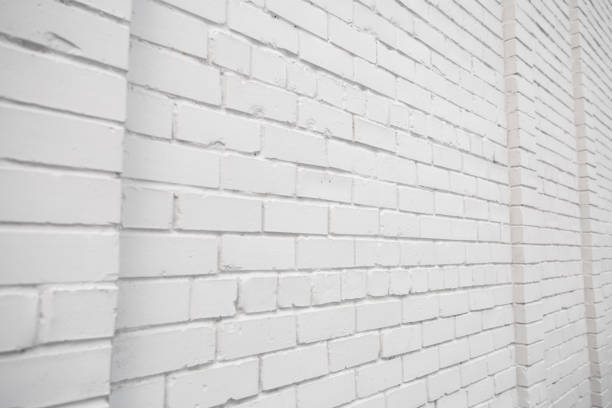 Blank ad space on a white brick wall in the street outside