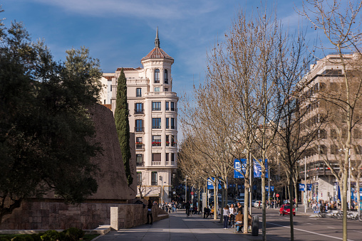 People walking in Serrano street near the Cristobal Colon (Christopher Columbus) park at Madrid city, Spain.