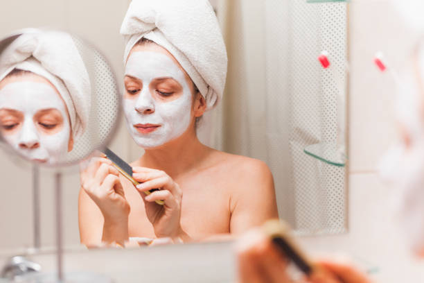 istock Young woman doing her nails in the bathroom 1135803882