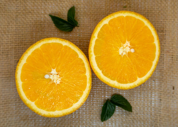 istock Fresh oranges cut in half and ready to eat or juice 1135807012