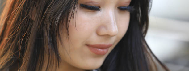 istock Young beautiful brunette woman with beautiful eyebrows, eyes closed 1135808063