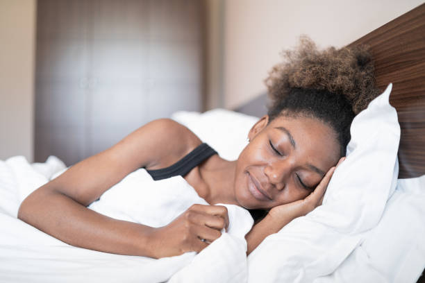 istock Tired african woman sleeping in bed 1135810535