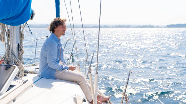 istock Single barefoot man with casual clothes on a yacht 1135814705