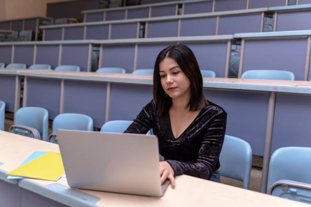 istock Woman working on laptop in a classroom 1135820496