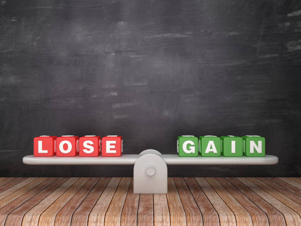 istock Seesaw Scale with LOSE GAIN Cubes on Chalkboard Background - 3D Rendering 1135820611