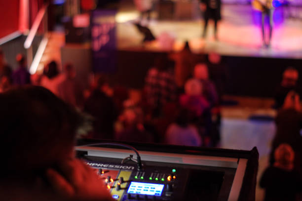 Technician in action Brunssum, the Netherlands, - March 04, 2018. Technician in action for  a  worship group, organised for the youth of the local Pentecostal Church. sound technician stock pictures, royalty-free photos & images