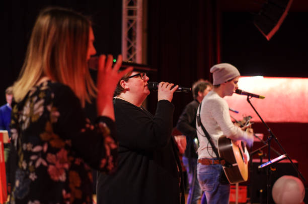 Worship concert Brunssum, the Netherlands, - March 04, 2018. Performence of a worship group, organised for the youth of the local Pentecostal Church. singer back stock pictures, royalty-free photos & images