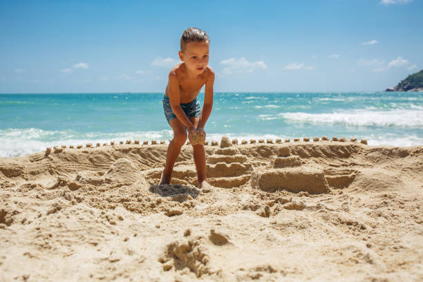 istock little boy built a sand castle 1135821826