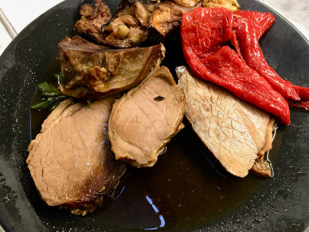 istock Roast Beef with Fried Vegetables in Black Plate. 1135822018