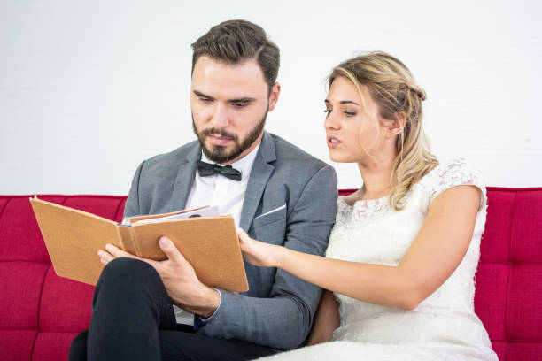 istock Couple Lover Helping choosing and looking at catalog album 1135822071