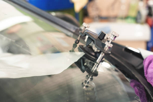 istock Close-up of polymer vacuum cracks installed on a cracked windshield for repairing cracks and chips 1135822730