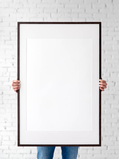Holding frame mockup. Photo Mockup. The man hold frame. For frames and posters design. Frame size 24x36 (61x91cm). Holding frame mockup. Photo Mockup. The man hold frame. For frames and posters design. Frame size 24x36 (61x91cm). 24 x 24 frame stock pictures, royalty-free photos & images