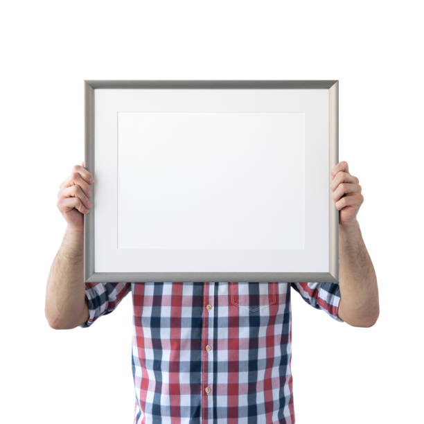 istock Holding frame mockup. Photo Mockup. The man hold frame. For frames and posters design. Frame size 16x12 (40x30cm). 1135826806