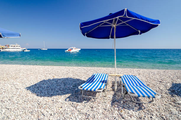 relaxing time in Afandou beach on Rhodes island in Greece beautiful beach with blue sea on Rhodes island in Greece afandou stock pictures, royalty-free photos & images