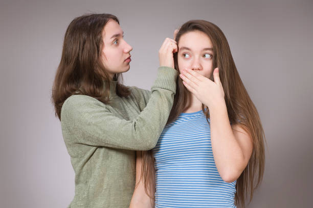 Young woman shows off her gray hair A young woman shows her gray hair white hair stock pictures, royalty-free photos & images