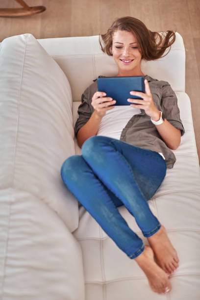 istock Young woman with digital tablet at home 1135827793