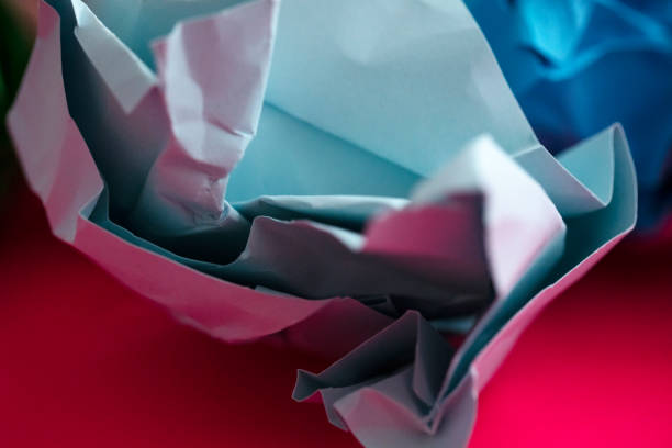 istock Multicolored Crumpled paper balls on red background. 1135827822