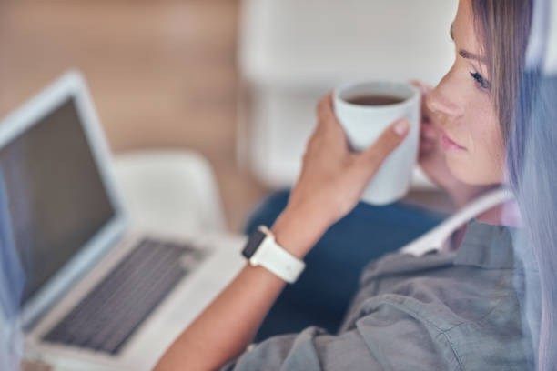 istock Young woman with laptop at home 1135828152