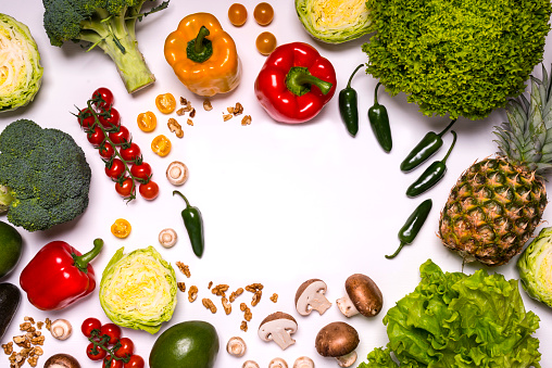 Fresh vegetables and fruits on white background. Detox diet. Different colorful fresh vegan food. Flat lay. Space for text.