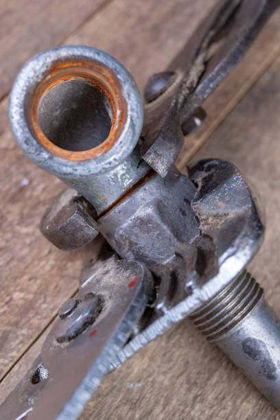 istock Hydraulic wrench and steel pipes on a workshop table. Minor mechanical work. Light background. 1135830797